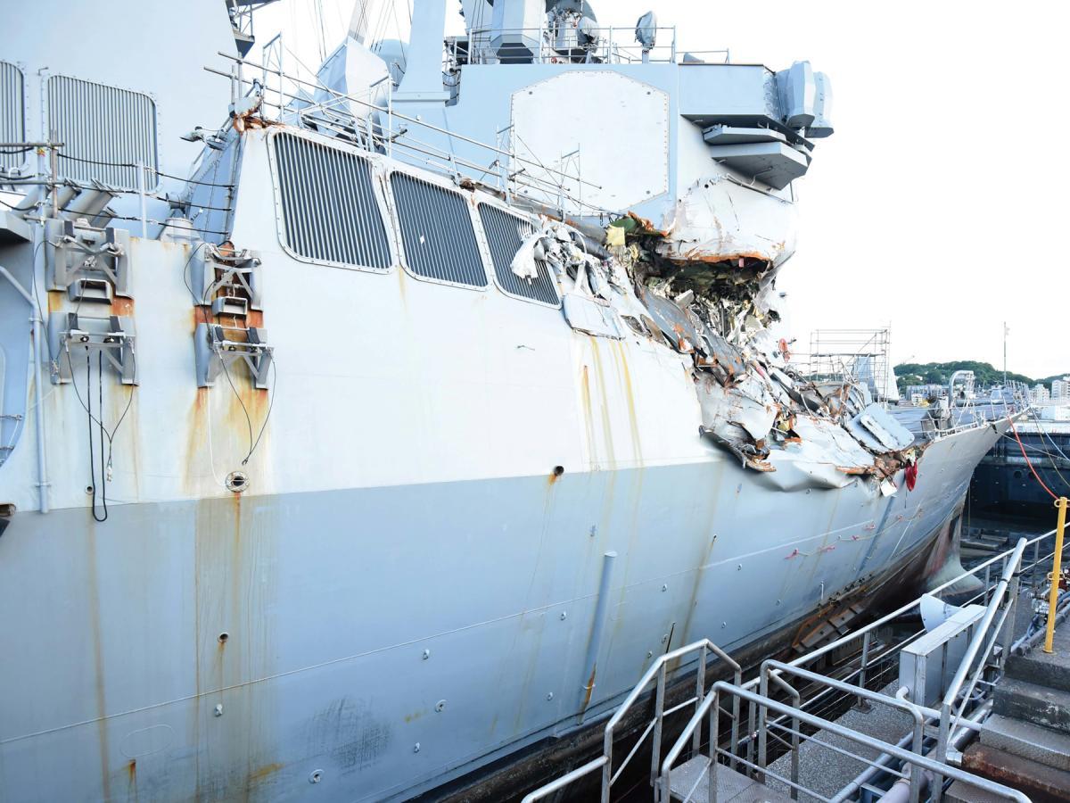 U.S. sailors repair the guided-missile destroyer USS Fitzgerald at Fleet Activities Yokosuka