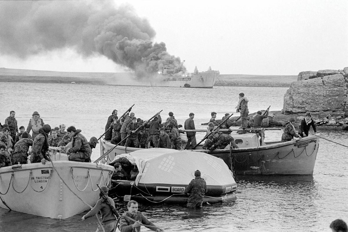Survivors come ashore from RFA Sir Galahad after the logistics ship is hit by Argentine A-4 Skyhawks while trying to unload troops