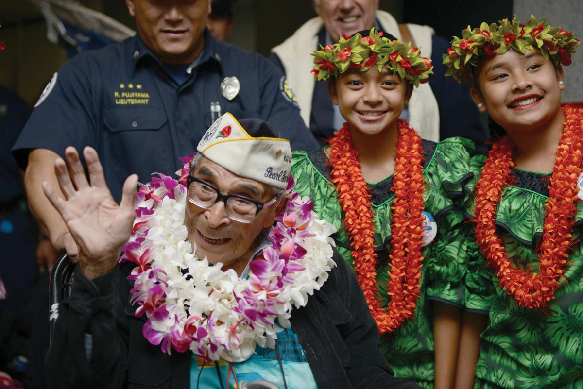 104-year-old Ray Chavez, oldest surviving Pearl Harbor veteran, waving.
