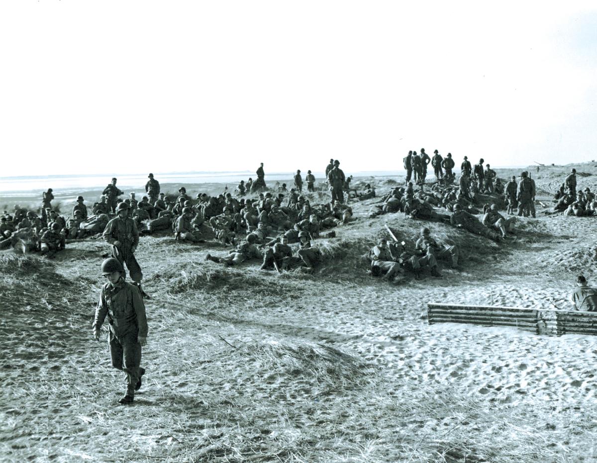 U.S. troops relax on a beach in Devon, England, during training maneuvers in 1943