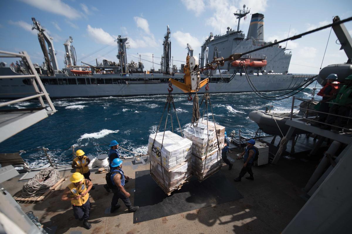 Sailors on the guided-missile destroyer USS Chung-Hoon (DDG-93) secure supplies during a replenishment at sea with the fleet oiler USNS Kanawah (T-AO-196) in the Gulf of Aden in February 2019.	