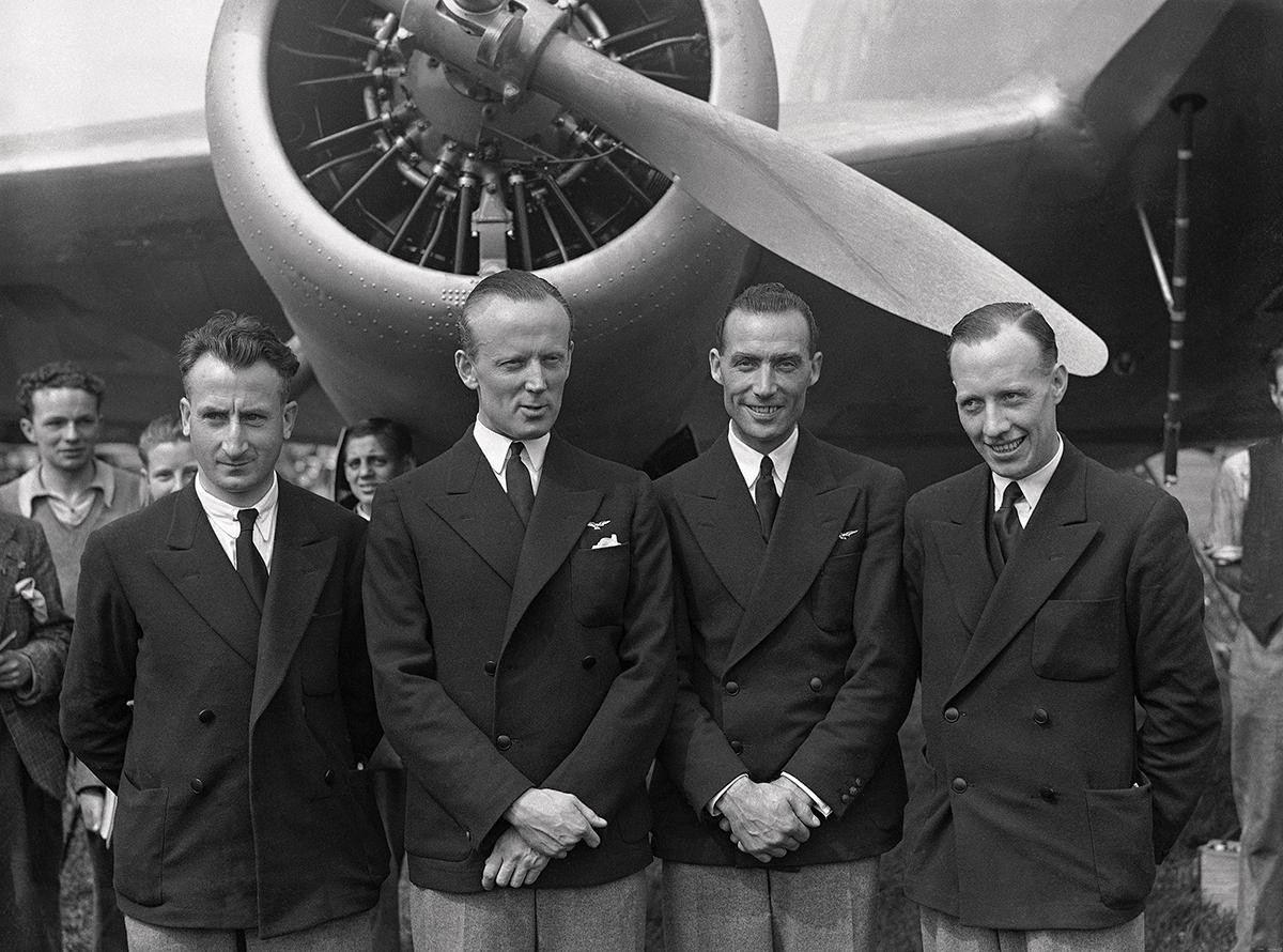 William Forbes-Sempill posing in front of an aircraft with others.