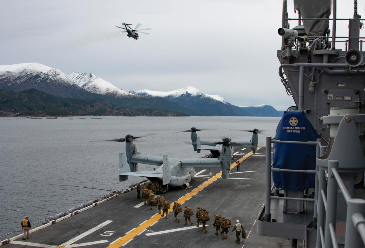 Marines board an MV-22B Osprey on the amphibious assault ship USS Iwo Jima (LHD-7) while conducting operations in the Alvund Fjord during Trident Juncture 2018.