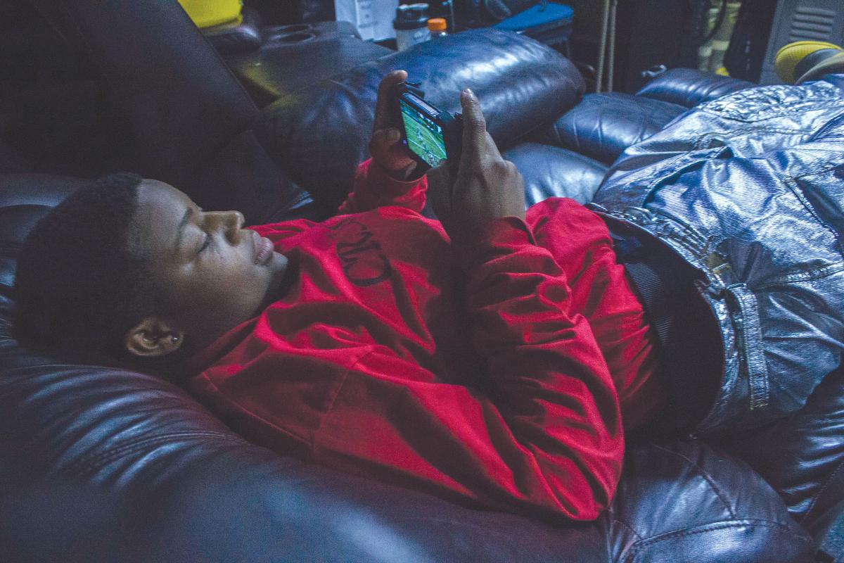 Aviation Boatswain’s Mate (Handling) Airman Ida Miller plays video games in between her crash and salvage watch aboard the amphibious assault ship USS Boxer.