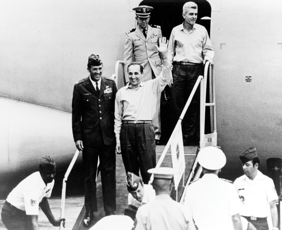 wo of the returned prisoners of war step from the second U.S. Air Force C-141 to leave Hanoi, at Clark Air Force Base, Philippine Islands, in February 1973.