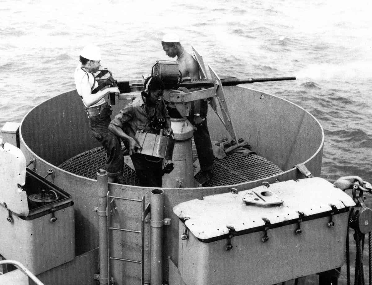 African-American Coast Guardsmen man a 20-mm antiaircraft gun on board a cutter in the North Atlantic during the war. 