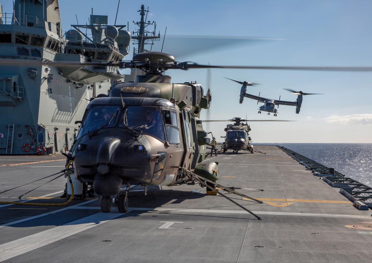 Royal Australian Navy MRH-90 helicopters and a U.S. Marine Corps V-22 Osprey on board HMAS Adelaide