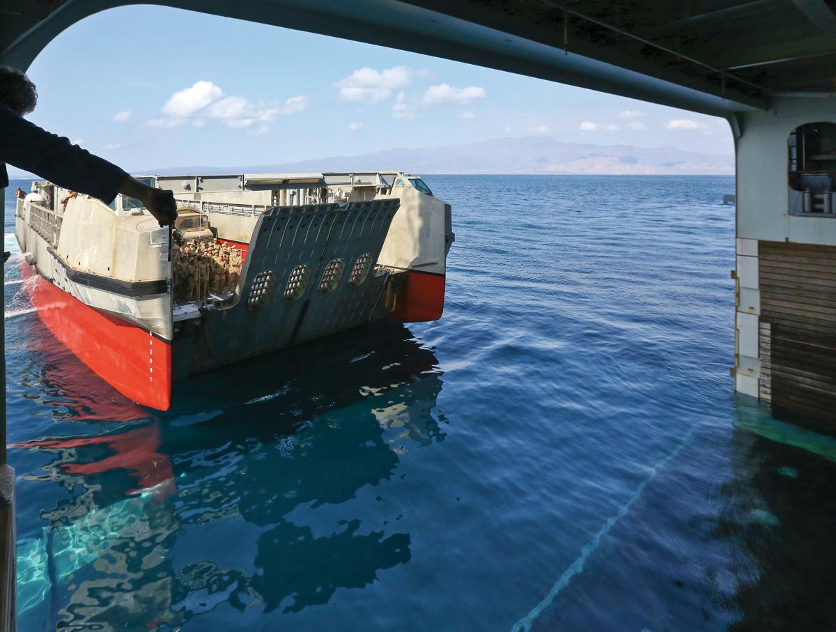 U.S. Army Soldiers transit on a French landing catamaran to the French navy Mistral-class amphibious assault ship LHD Tonnerre.