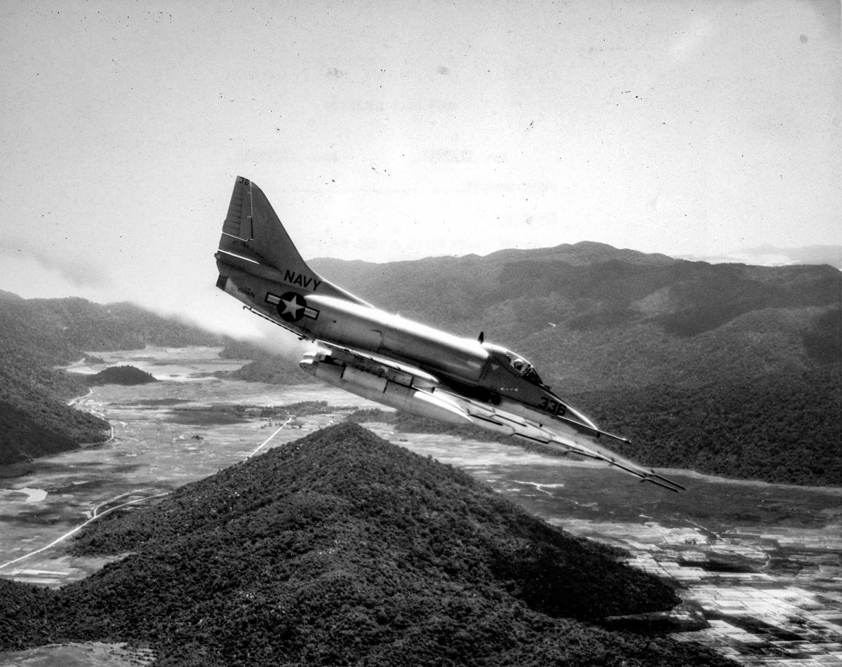 An A-4E VA-23 fires a load of 3" rockets on the Viet Cong forces