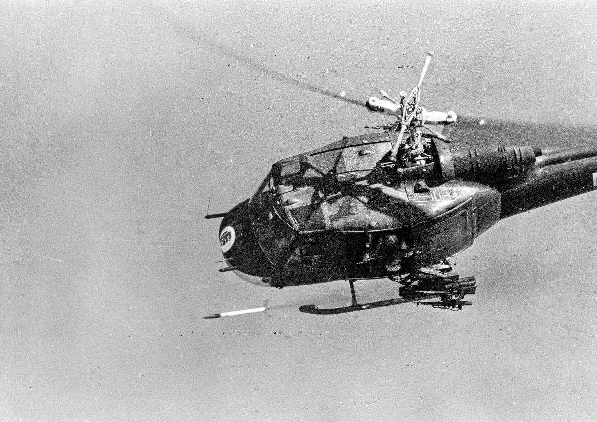 A Navy Huey banks hard as it fires a 2.75-inch rocket over the Mekong Delta.