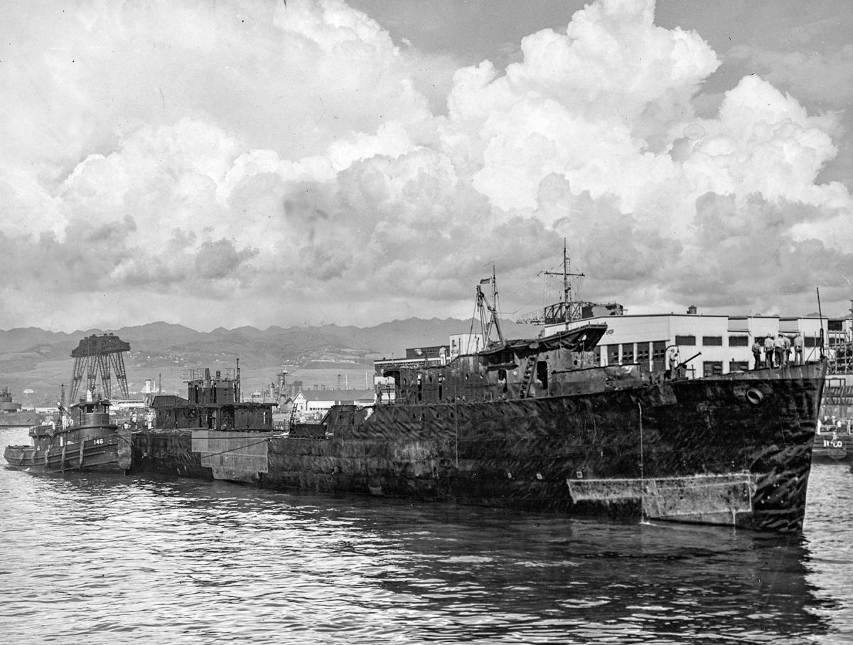 USS Downes (DD-375) being floated out of drydock by the tug Hoga (YT-146)