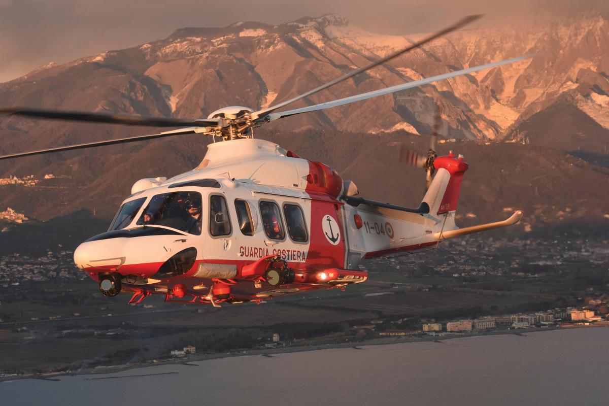 Italian Coast Guard PH-139B helicopter taken in flight at sunset.