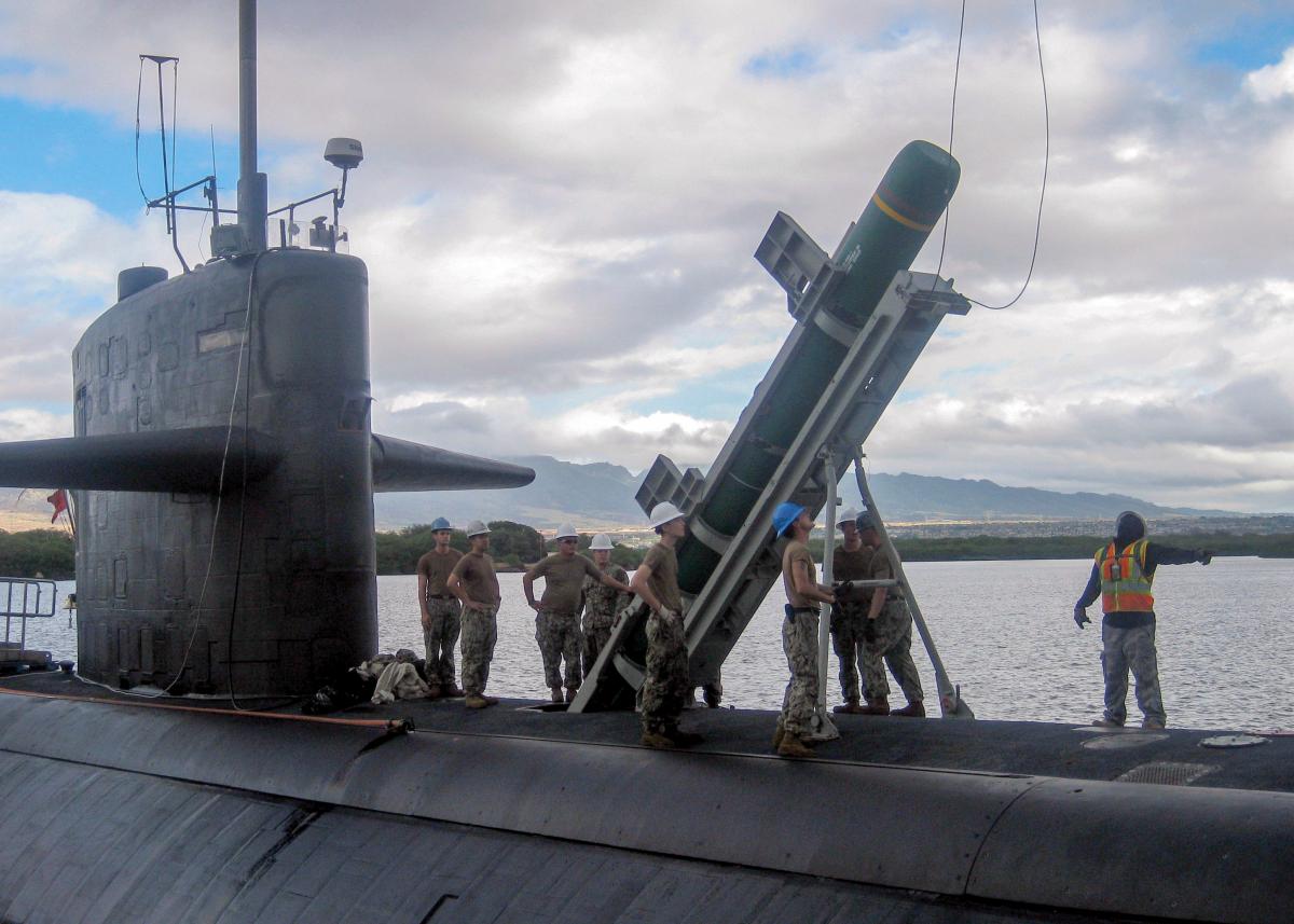 Sailors load a Harpoon anti-ship cruise missile aboard the Los Angeles-class fast-attack submarine USS Olympia (SSN 717) as part of the biannual Rim of the Pacific (RIMPAC) maritime exercise, July 3, 2018