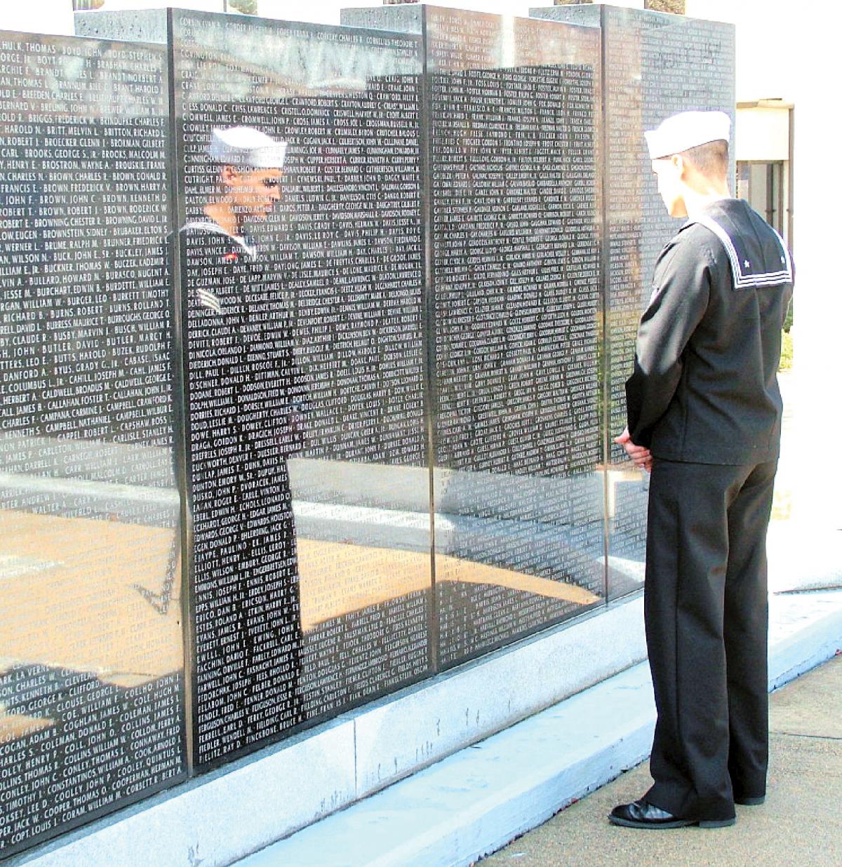 A sailor reflects on those whose losses, on the Thresher and other submarines, are memorialized on the Wall of Honor at Naval Submarine Base New London in Groton, Connecticut.