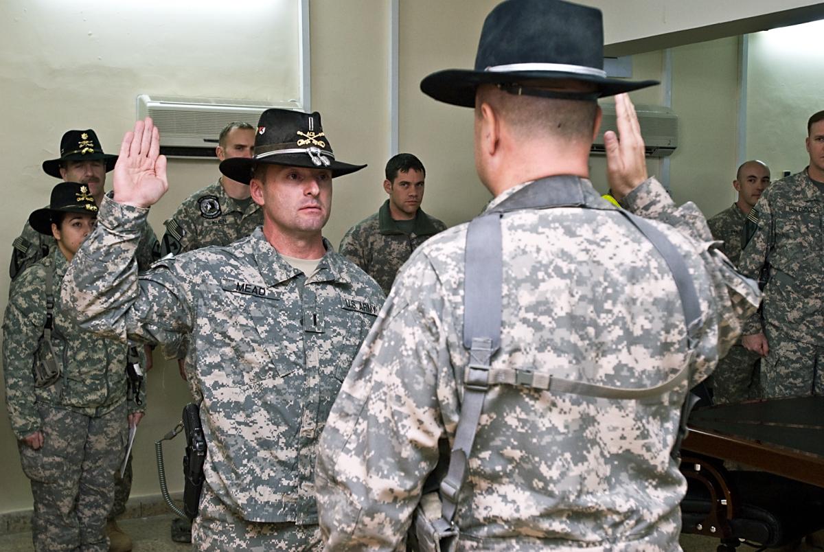 Newly promoted Chief Warrant Officer 5 Cliff Mead (left), of Copperas Cove, Texas, battalion maintenance officer and UH-60 Black Hawk pilot, 2nd Battalion, 227th Aviation Regiment, 1st Air Cavalry Brigade, 1st Cavalry Division, U.S. Division-Center, reaffirms his commitment to the Army by taking the Oath of Office, administered by Chief Warrant Officer 5 Don Washabaugh, from Collingswood, N.J., brigade aviation maintenance officer, 1st ACB