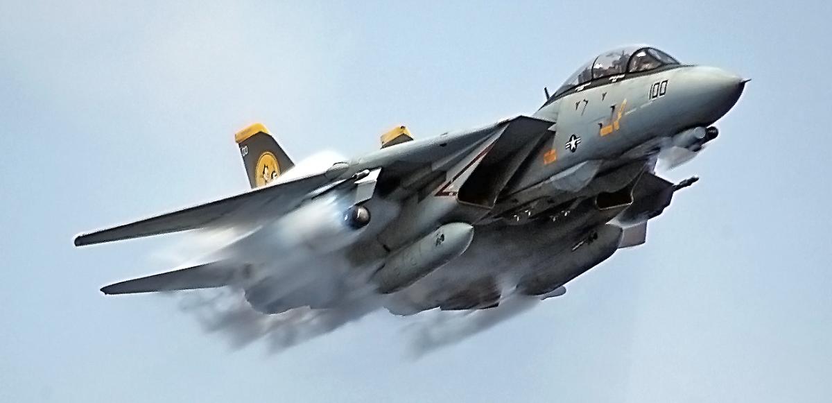 An F-14D Tomcat from VF-31, aircraft number 100, makes a fly-by over the aircraft carrier USS Theodore Roosevelt (CVN-71) in July 2006