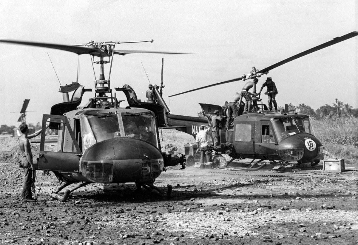 Helicopter Attack (Light) Squadron 3 personnel service two of the unit's UH-1B helicopters.
