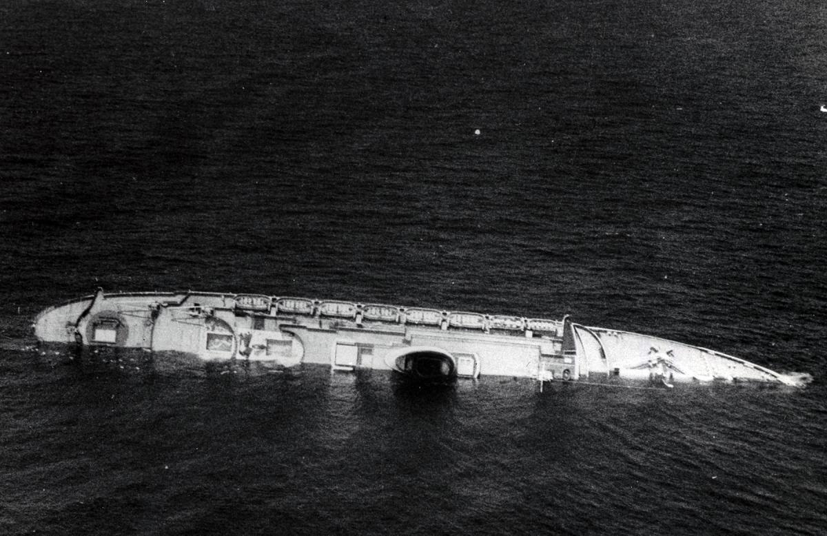 The Andrea Doria rolling onto her starboard side
