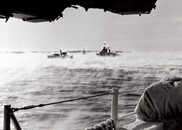 Mists cover the Atlantic as an Allied convoy steams to its destination early in the morning. The many victories of land-based Allied aircraft during World War II would not have been possible without the  logistics train defended by the U.S. Navy.