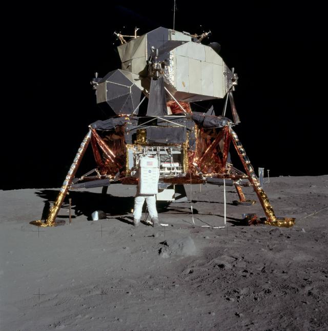 Neil Armstrong checking the LLM's modular equipment storage assembly.