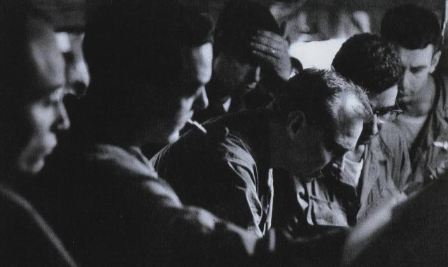 During a tense moment in the main Khe Sanh command bunker, officers gather around Baig’s target map as the captain (second from right) briefs the base’s commander, Colonel David E. Lownds (third from right). Baig’s targeting for B-52 strikes played a key role in defeating a major enemy attack on the night of 29 February–1 March.