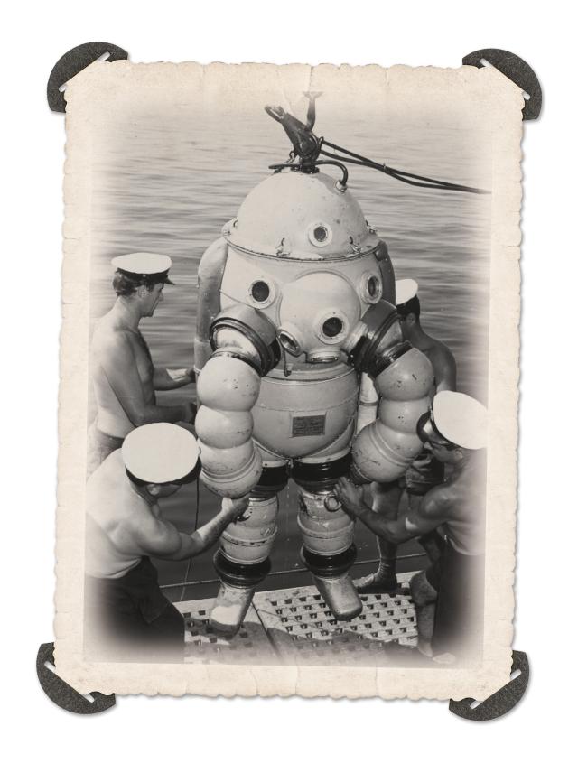 Take her down! Divers on board the Proteo prepare to lower away a fellow deep-sea diver in the ship’s 800-pound armored diving suit.