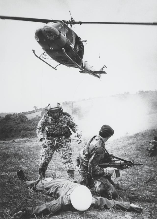 A Turkish para-rescueman prepares to evacuate  a “downed” Turkish pilot while U.S. Air Force  security police provide cover during the final  phase of NATO Exercise Display Determination 87 held in the Turkish section of Thrace.