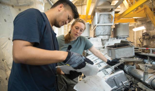 Adding civilian mariners to a Sea Service ship is not new idea. The Military Sealift Command includes civilian mariners hired as federal employees in Navy crews. Here, a civilian mariner reviews procedures for replacing a fuel injector on board the USNS Spearhead (T-EPF-1).  