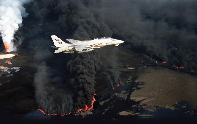 An F-14 flies over a burning oil field during Operation Desert Storm. Though technically a joint operation, services rarely flew joint missions.