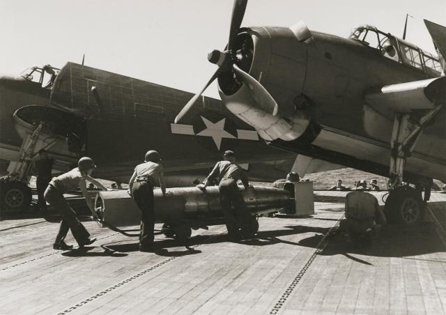 Sailors on board the USS San Jacinto (CVL-30) arm a Torpedo Squadron 51 TBM torpedo bomber at the outset of the Battle off Cape Engaño, 25 October 1944. While the Third Fleet was thus engaged, the Seventh Fleet was exposed to the Japanese onslaught farther south.