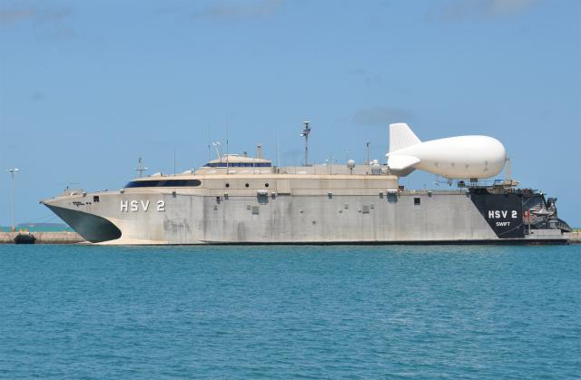 Modified car ferries like the Swift (HSV-2), shown here in 2013 moored at Naval Air Station Key West, have the ability to rapidly embark and debark tanks and semi-tractor-trailer trucks, host helicopter and unmanned aerial vehicle detachments, and employ bulky items such as balloons and blimps.