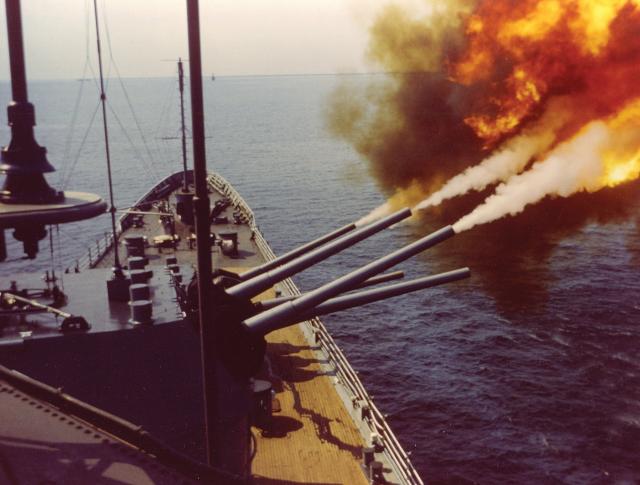 The USS St. Paul (CA-73) fires her forward 8-inch guns