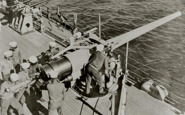 Marines man a 5-inch/51-caliber gun