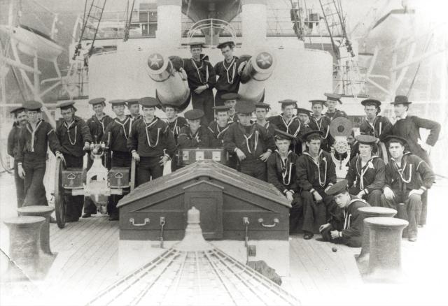 Some apprentice boys and the ship’s chaplain on board the USS Olympia 