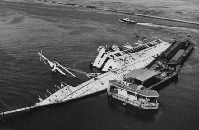 U.S. Navy and Egyptian salvage divers prepare to clear an abandoned vessel from the Suez Canal in 1974. 