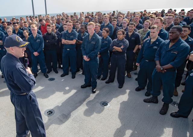 Officers and sailors on board the amphibious dock landing ship USS Fort McHenry (LSD-43) listen to their commanding officer during an all-hands call in the Fifth Fleet area of operations. White naval officers should question why African Americans are significantly underrepresented at the senior ranks.