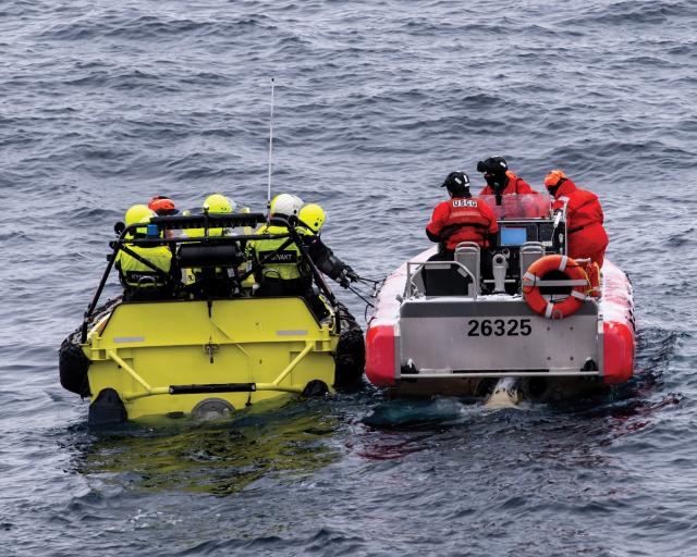Boats from the Healy and Svalbard conduct a passenger exchange in the Barents Sea.