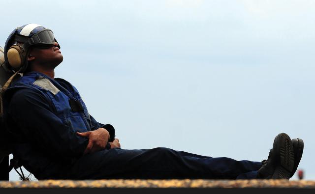 A boatswain’s mate takes a break before flight operations
