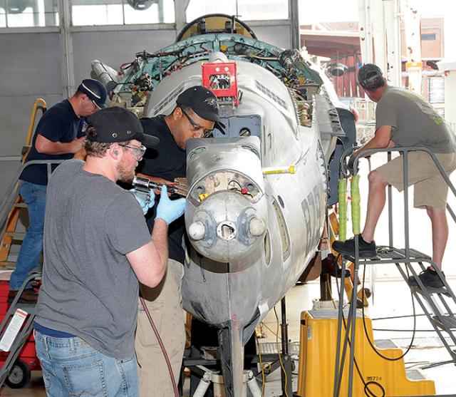 Depot-level maintenance is performed on a Navy jet