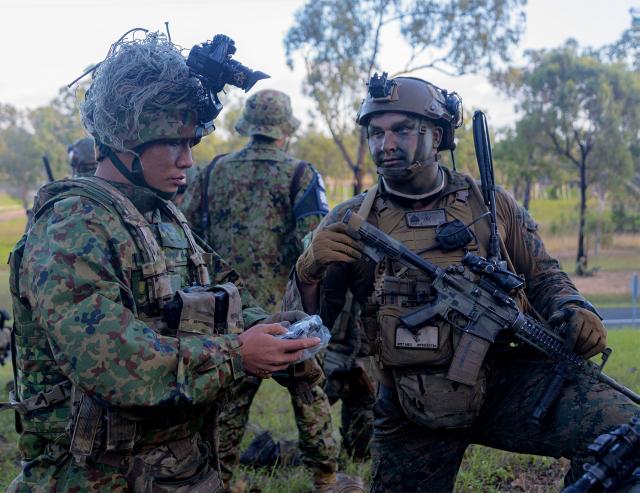 Marines of Battalion Landing Team 2/1, 31st Marine Expeditionary Unit, inspect gear with the Amphibious Rapid Deployment Regiment, Japan Ground Self-Defense Force, at Midge Point, Australia, during Exercise Talisman Sabre 23. Expanded education on adversary culture and doctrine would better prepare NCOs to adapt to complicated environments.