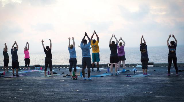 While in the Navy, sailors should take care of themselves, mind, body, and soul. This includes staying physically and mentally healthy with activities such as exercise or on-ship yoga, as pictured here on board the USS Iwo Jima (LHD-7).