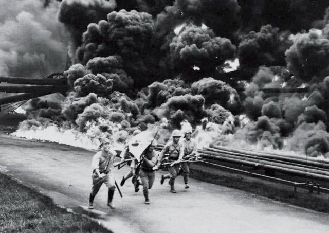  Japanese troops make their way through Balikpapan’s burning oilfields