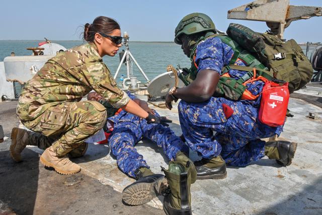 A member of the U.S. Coast Guard  and members of the Cameroon Armed Forces and participate in a visit, board, search, and seizure drill during Obangame Express 2019. The exercise, sponsored by U.S. Africa Command, is designed to increase at-sea cooperation to counter illicit activity.
