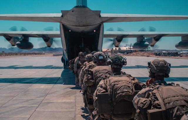 Marines with 1st Battalion, 2d Marine Regiment (1/2), 2d Marine Division, board a KC-130J Super Hercules 