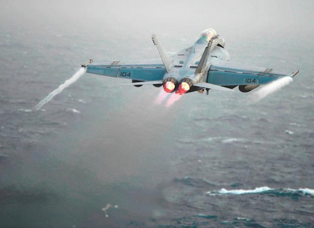 An F/A-18F Super Hornet assigned to the Bounty Hunters of Strike Fighter Squadron (VFA) 2 launches from the flight deck of the Nimitz-class aircraft carrier USS Abraham Lincoln (CVN-72)