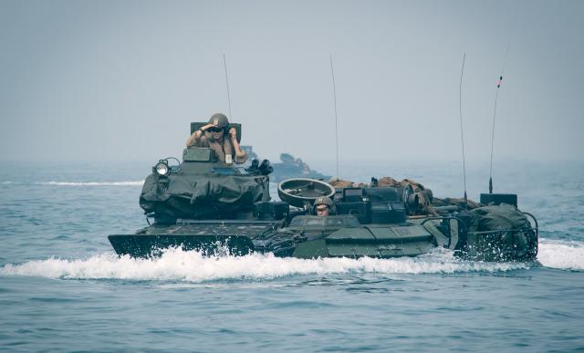 Amphibious assault vehicles (AAVs) from the USS Oak Hill (LSD-51) transit the Arabian Gulf in February. The AAVs are slow, short-legged, and cannot provide fire support until after they reach the beach—note the protective cover on the turret cannon during transit.