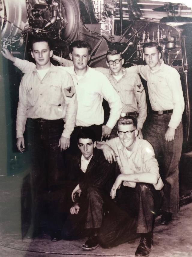 Portrait of Aviation Structural Mechanic Third Class Joe Crutcher and other mechanics
