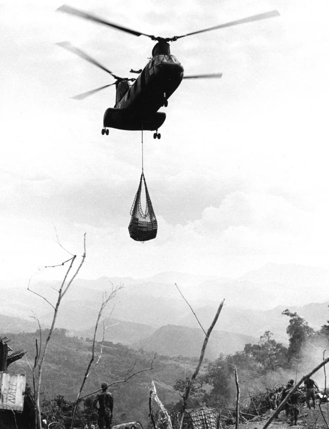 A Marine CH-46 delivers a net of supplies to a combat-support base in Vietnam