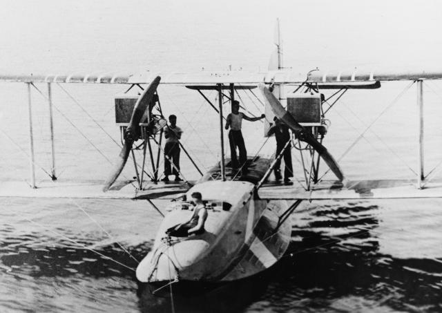An F-5L approaching the tender Shawmut (CM-4) in Guantanamo Bay, Cuba, in 1921. The aircraft underwent several redesigns and modifications, especially engine upgrades, during its development and production.