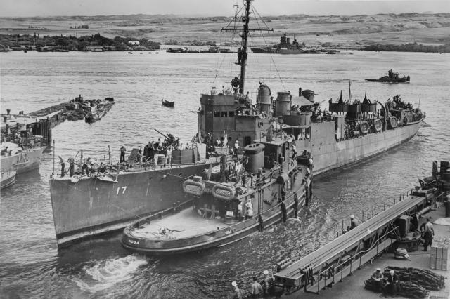 Performing routine tug work, the Hoga assists the destroyer-turned-minelayer USS Montgomery (DM-17) at Pearl Harbor in May 1943.